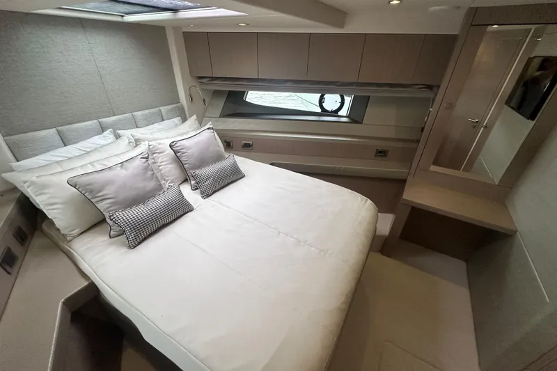  Yacht Photos Pics Luxurious bedroom interior of 2018 Sunseeker Manhattan 52 yacht with elegant bedding and modern design.