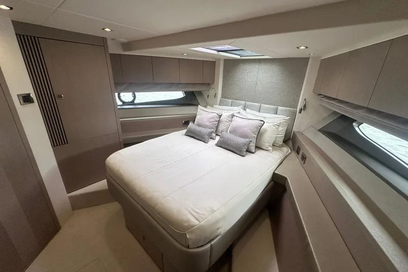  Yacht Photos Pics Luxurious bedroom interior of 2018 Sunseeker Manhattan 52 yacht with modern design and cozy bedding.