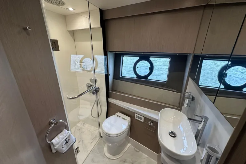 Yacht Photos Pics Luxurious bathroom in 2018 Sunseeker Manhattan 52 yacht with modern fixtures and ocean view.