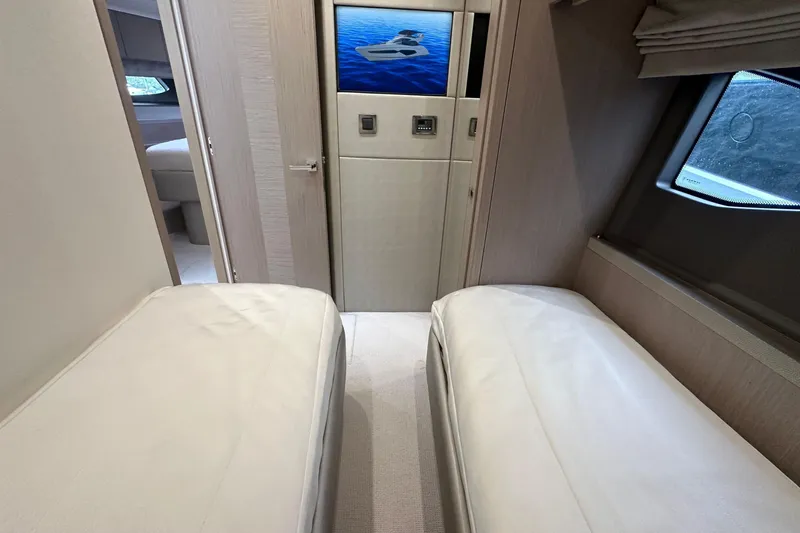  Yacht Photos Pics Interior of 2018 Sunseeker Manhattan 52 yacht with twin beds and window view.