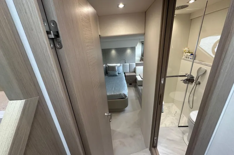  Yacht Photos Pics Luxurious interior of 2018 Sunseeker Manhattan 52 yacht, featuring bedroom and modern bathroom.