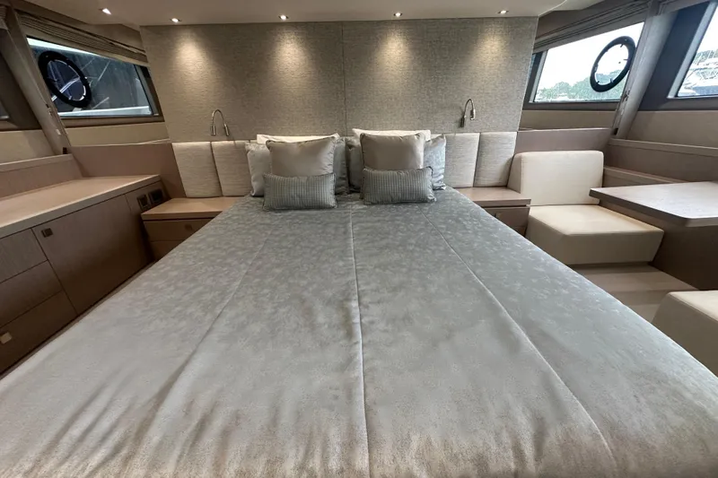  Yacht Photos Pics Luxurious bedroom interior of 2018 Sunseeker Manhattan 52 yacht with elegant bedding and seating.