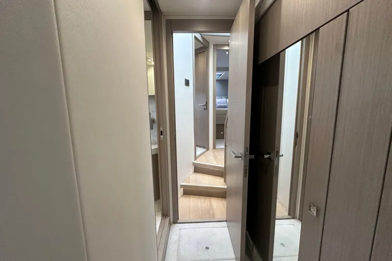  Yacht Photos Pics Interior hallway of 2018 Sunseeker Manhattan 52 yacht, featuring modern wood finishes.