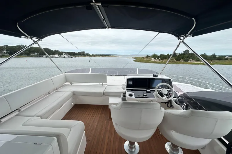  Yacht Photos Pics Flybridge of 2018 Sunseeker Manhattan 52 yacht with helm, seating, and scenic water view.