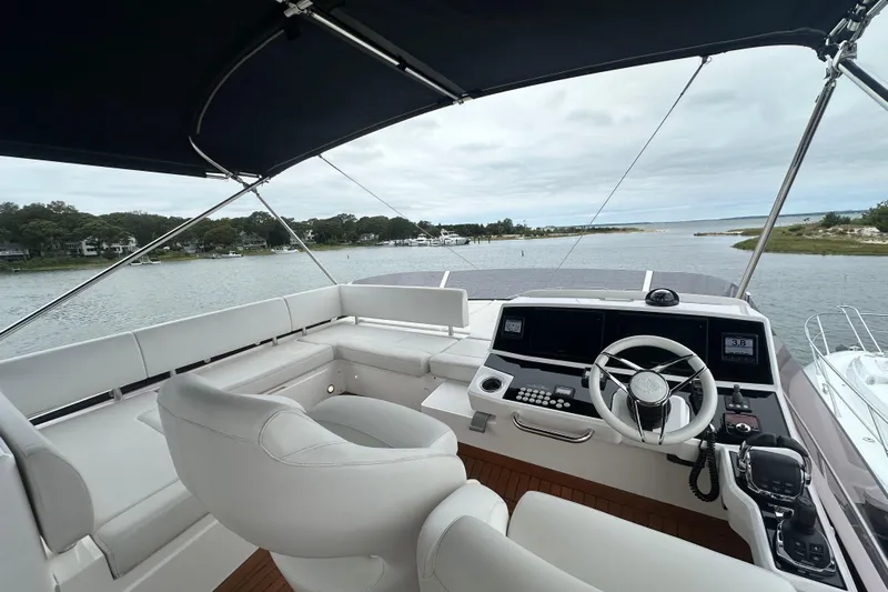  Yacht Photos Pics Flybridge view of 2018 Sunseeker Manhattan 52 yacht with modern helm and seating.