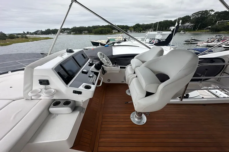  Yacht Photos Pics Luxurious 2018 Sunseeker Manhattan 52 yacht helm with modern controls and plush seating.