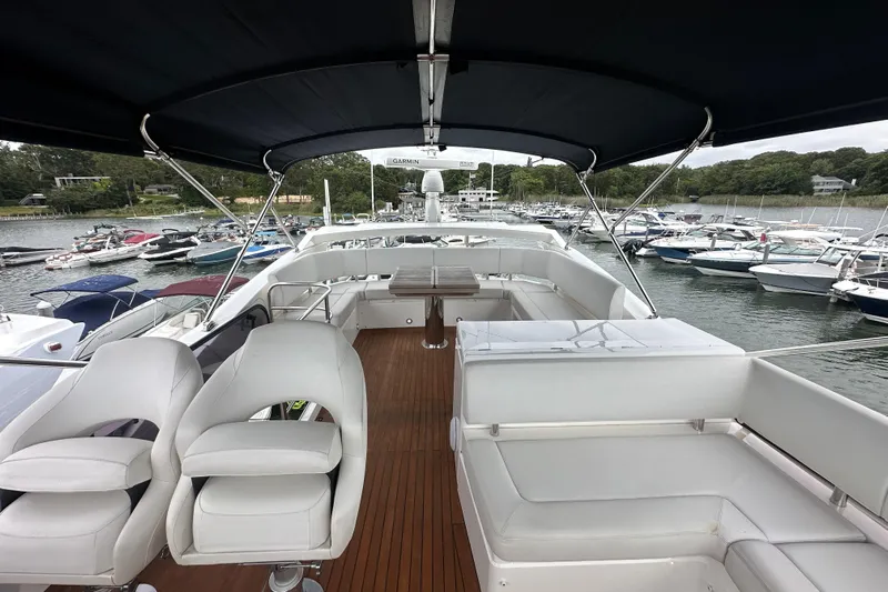  Yacht Photos Pics 2018 Sunseeker Manhattan 52 yacht interior with seating, docked at marina.
