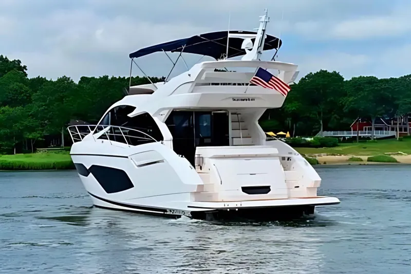 Yacht Photos Pics 2018 Sunseeker Manhattan 52 yacht cruising on a serene waterway.