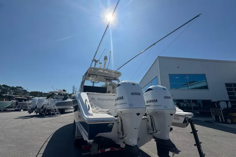  Yacht Photos Pics 2020 Pursuit OS 325 Offshore boat with twin Yamaha engines in a sunny marina.