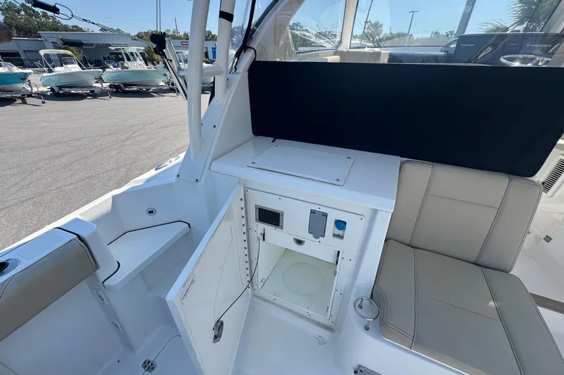  Yacht Photos Pics 2020 Pursuit OS 325 Offshore boat interior with seating and storage compartments.