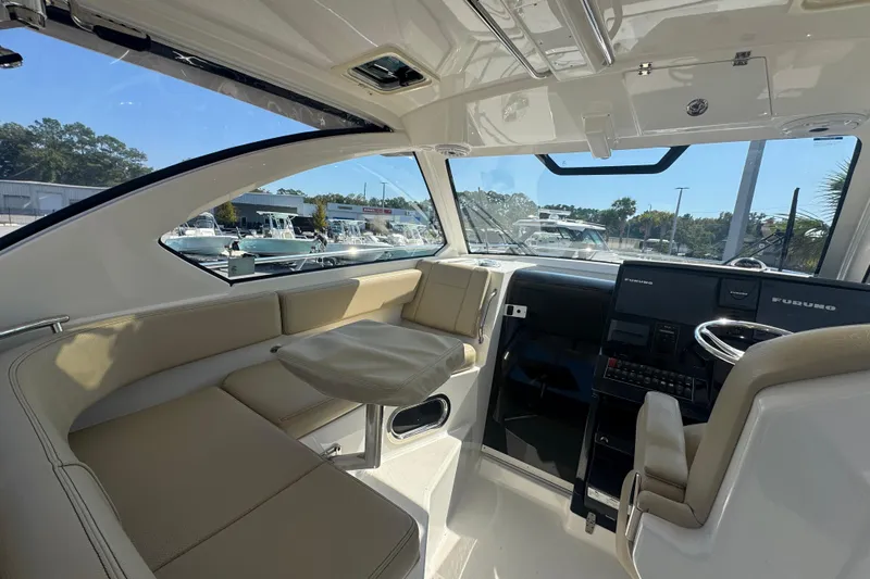 Yacht Photos Pics 2020 Pursuit OS 325 Offshore boat interior with seating and navigation console.