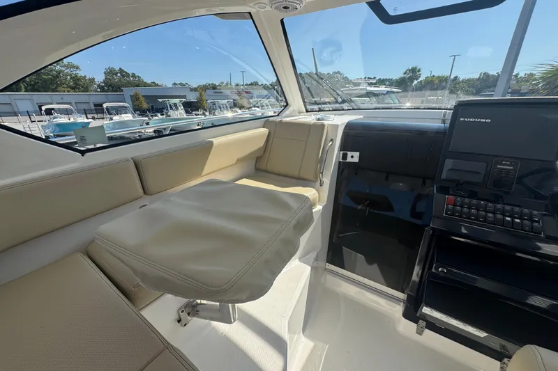  Yacht Photos Pics 2020 Pursuit OS 325 Offshore boat interior with seating and navigation equipment.