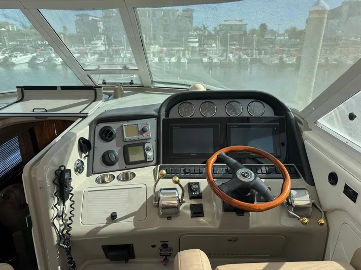 Lazy Gray Yacht Photos Pics 2008 Sea Ray 40 Motor Yacht helm with wooden steering wheel and navigation instruments.