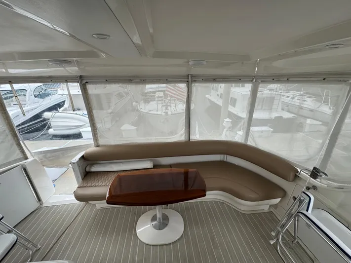Lazy Gray Yacht Photos Pics 2008 Sea Ray 40 Motor Yacht interior with curved seating and wooden table.
