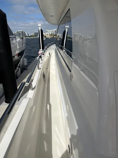 Arlene Yacht Photos Pics Side view of a 2009 Horizon Vision 74 yacht docked at a marina.