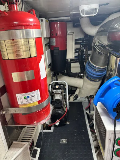 Arlene Yacht Photos Pics Engine room of 2009 Horizon Vision 74 yacht with fire extinguisher and machinery.