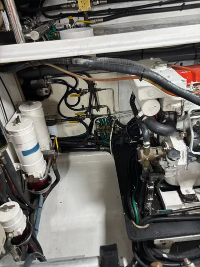 Arlene Yacht Photos Pics Engine room of a 2009 Horizon Vision 74 yacht, showcasing mechanical components and piping.