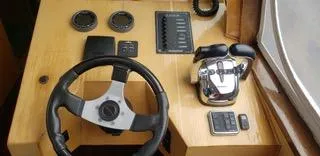  Yacht Photos Pics Steering console of 2010 Mission-Craft Mis 35 boat with controls and gauges.