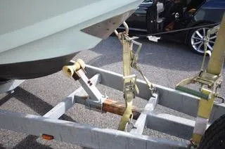  Yacht Photos Pics Boat trailer securing a 2010 Mission-Craft Mis 35, parked on asphalt.