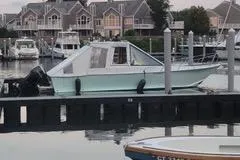  Yacht Photos Pics Boat docked at marina, Mission-Craft Mis 35, 2010 model, with waterfront homes in background.