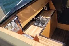  Yacht Photos Pics Compact kitchen area on 2010 Mission-Craft Mis 35 boat with wooden countertops and sink.