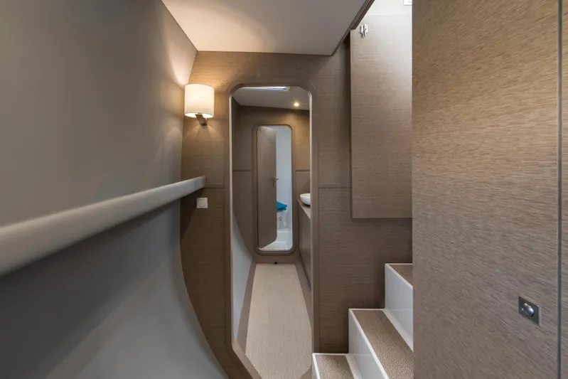 Dauntless Yacht Photos Pics Interior of 2022 NEEL 51 yacht, featuring modern hallway and stairs with elegant lighting.