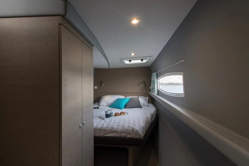 Dauntless Yacht Photos Pics Cozy bedroom interior of 2022 NEEL 51 yacht with modern design and soft lighting.