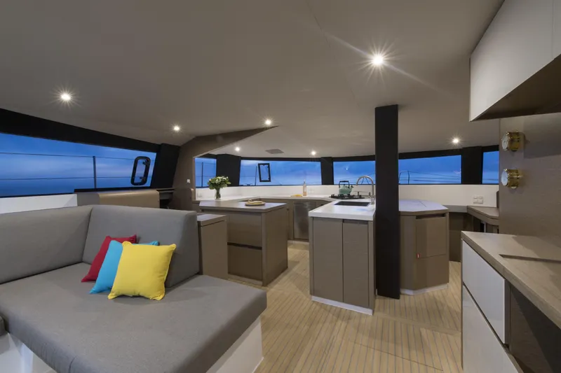 Dauntless Yacht Photos Pics Luxurious NEEL 51 yacht interior, modern design, spacious seating, vibrant cushions, 2022 model.