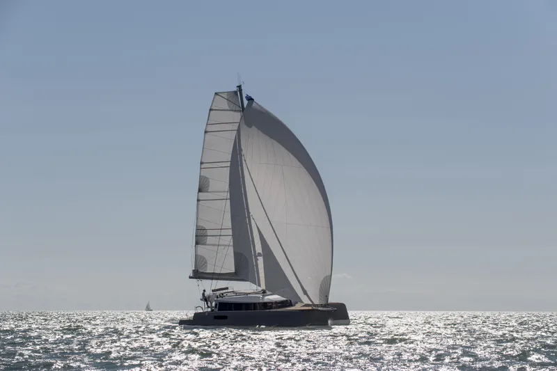 Dauntless Yacht Photos Pics Sailing yacht NEEL 51, 2022 model, gliding on shimmering sea under clear sky.