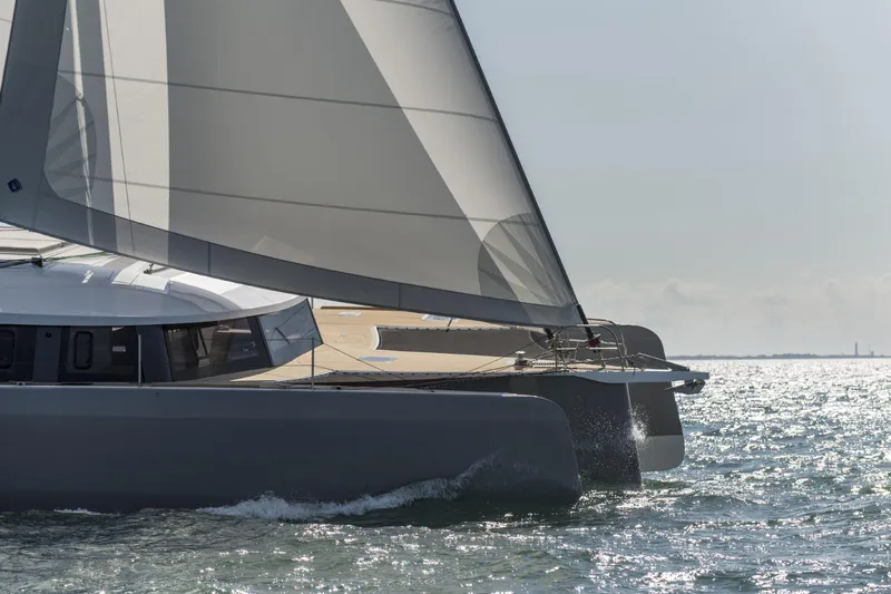 Dauntless Yacht Photos Pics Sailing trimaran NEEL 51 gliding on water, 2022 model, with sleek design and large sails.