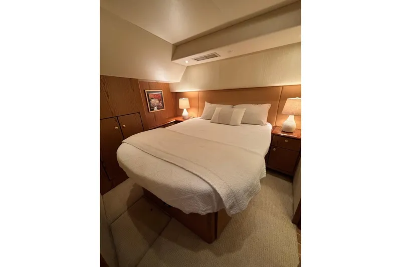 Havana Run Yacht Photos Pics Luxurious bedroom interior of 2007 Ocean Yachts 46 Super Sport, featuring cozy bed and warm lighting.