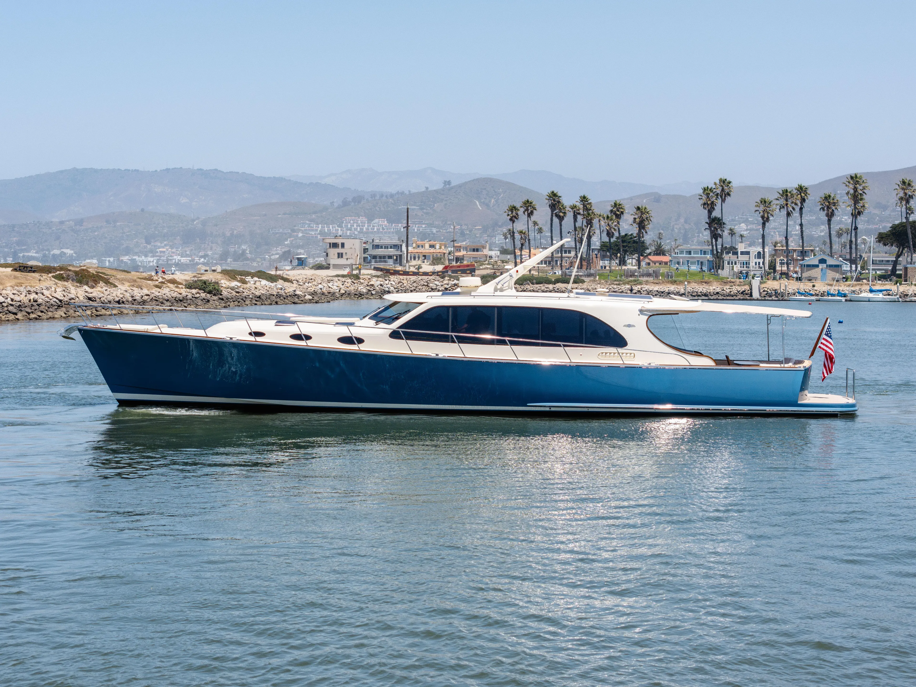 Margin Yacht Photos Pics 2025 Palm Beach Motor Yachts PB70 cruising in a scenic coastal area.