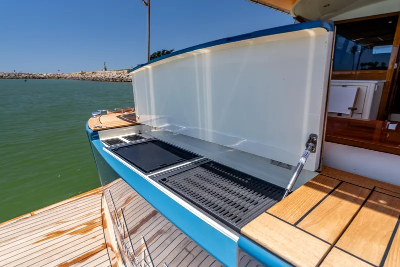 Margin Yacht Photos Pics Outdoor kitchen on 2025 Palm Beach Motor Yachts PB70, featuring grill and sink by the water.