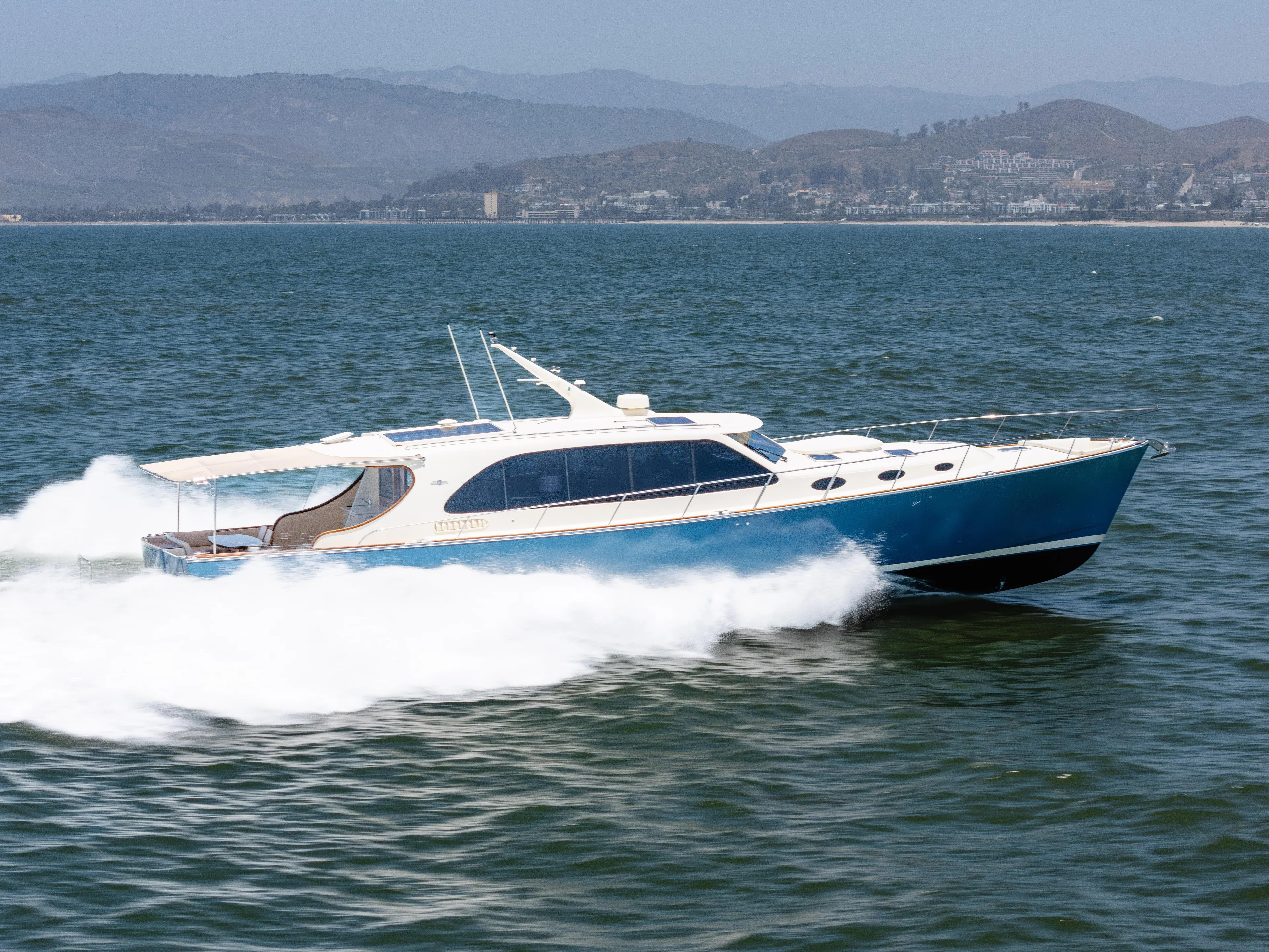 Margin Yacht Photos Pics 2025 Palm Beach Motor Yachts PB70 cruising on open water, showcasing sleek design and speed.
