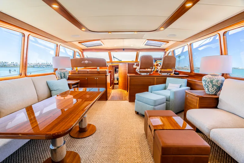 Margin Yacht Photos Pics Luxurious interior of 2025 Palm Beach Motor Yachts PB70, featuring elegant wood finishes and plush seating.