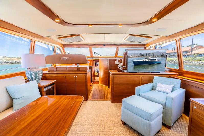 Margin Yacht Photos Pics Luxurious interior of 2025 Palm Beach Motor Yachts PB70, featuring elegant wood finishes and plush seating.