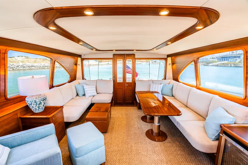 Margin Yacht Photos Pics Luxurious interior of 2025 Palm Beach Motor Yachts PB70 with elegant wood and plush seating.