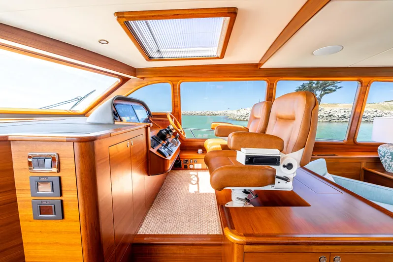 Margin Yacht Photos Pics Luxurious interior of 2025 Palm Beach Motor Yachts PB70 with leather seating and wooden finishes.