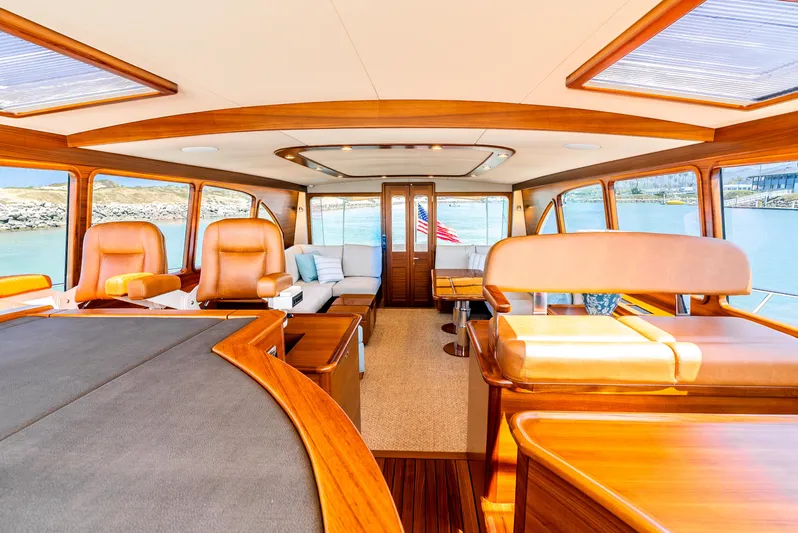 Margin Yacht Photos Pics Luxurious interior of 2025 Palm Beach Motor Yachts PB70, featuring elegant wood finishes and plush seating.