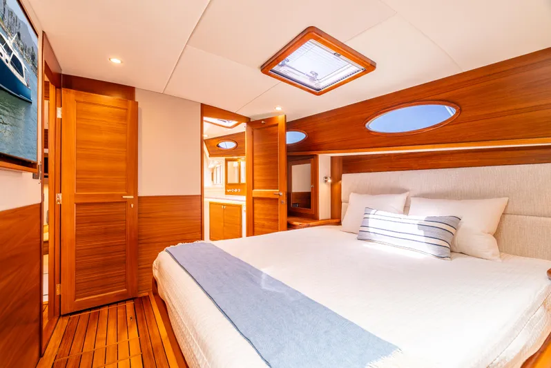 Margin Yacht Photos Pics Luxurious cabin interior of 2025 Palm Beach Motor Yachts PB70 with elegant wood finishes.