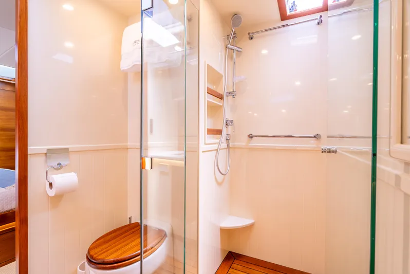 Margin Yacht Photos Pics Luxurious bathroom in 2025 Palm Beach Motor Yachts PB70, featuring glass shower and wooden accents.