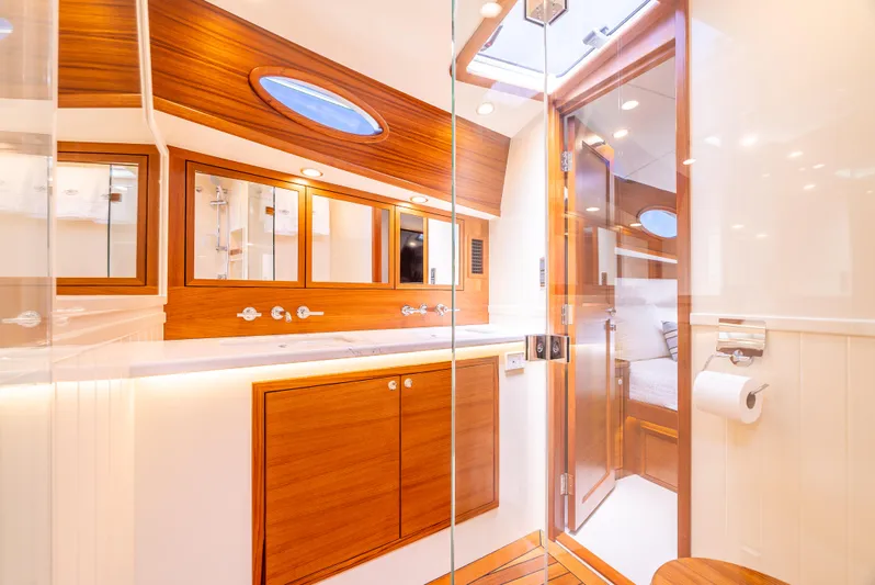 Margin Yacht Photos Pics Luxurious bathroom interior of 2025 Palm Beach Motor Yachts PB70, featuring elegant wood finishes.