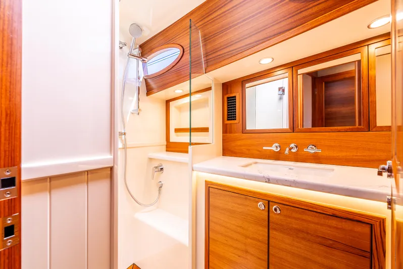 Margin Yacht Photos Pics Luxurious bathroom in 2025 Palm Beach Motor Yachts PB70, featuring elegant wood finishes and modern fixtures.