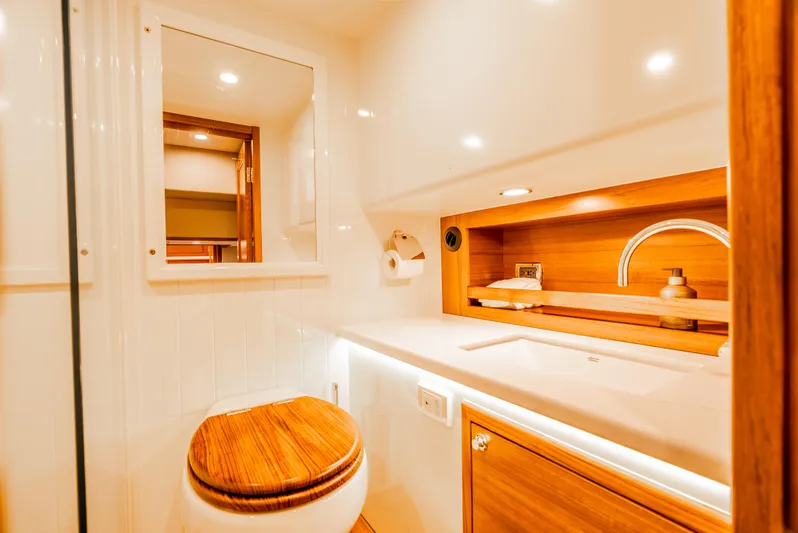 Margin Yacht Photos Pics Luxurious bathroom in 2025 Palm Beach Motor Yachts PB70, featuring elegant wood accents and modern fixtures.
