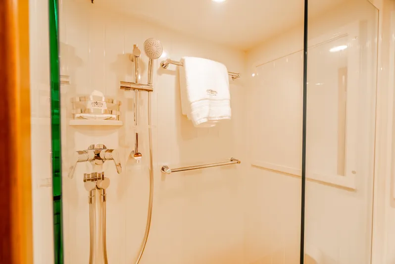 Margin Yacht Photos Pics Luxurious shower in 2025 Palm Beach Motor Yachts PB70, featuring elegant fixtures and plush towels.