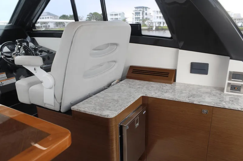 Dream Weaver Yacht Photos Pics Interior of 2021 Ocean Alexander 45 Divergence Coupe with helm seat and marble countertop.