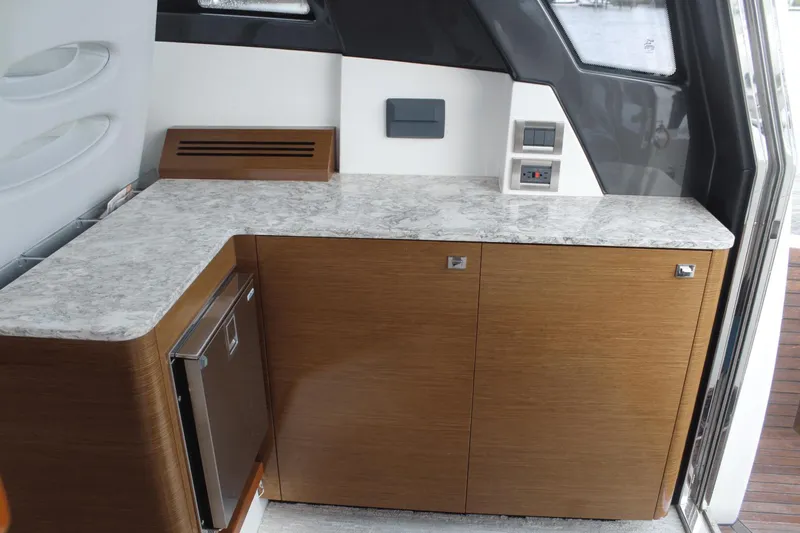 Dream Weaver Yacht Photos Pics 2021 Ocean Alexander 45 Divergence Coupe interior with sleek cabinetry and marble countertop.