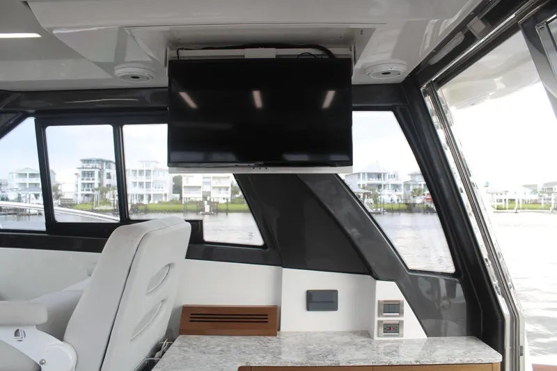 Dream Weaver Yacht Photos Pics Interior of 2021 Ocean Alexander 45 Divergence Coupe with TV and luxurious seating.