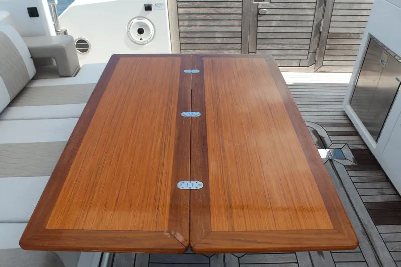 Dream Weaver Yacht Photos Pics Luxury wooden table on 2021 Ocean Alexander 45 Divergence Coupe yacht deck.
