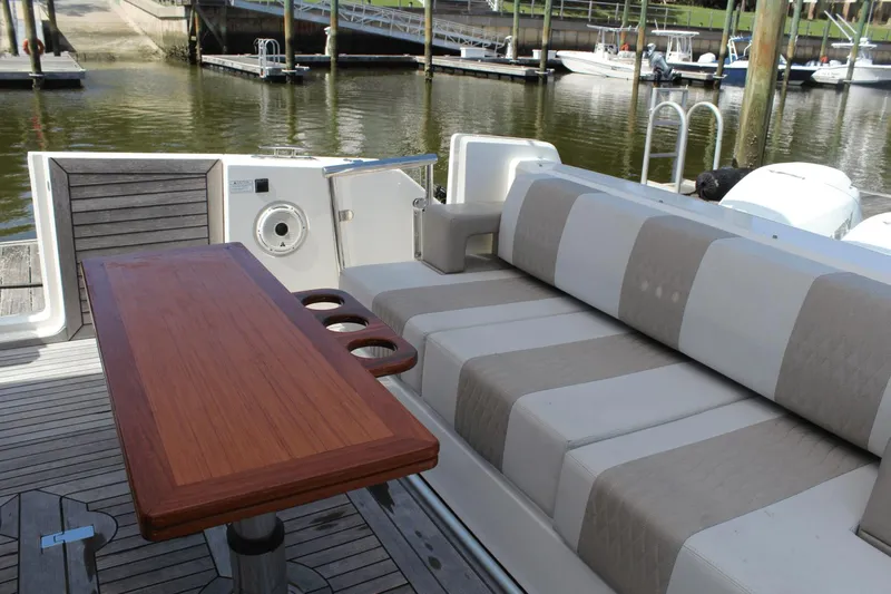 Dream Weaver Yacht Photos Pics 2021 Ocean Alexander 45 Divergence Coupe interior with striped seating and wooden table.